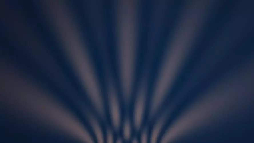 Abstract wave pattern in warm orange on dark blue