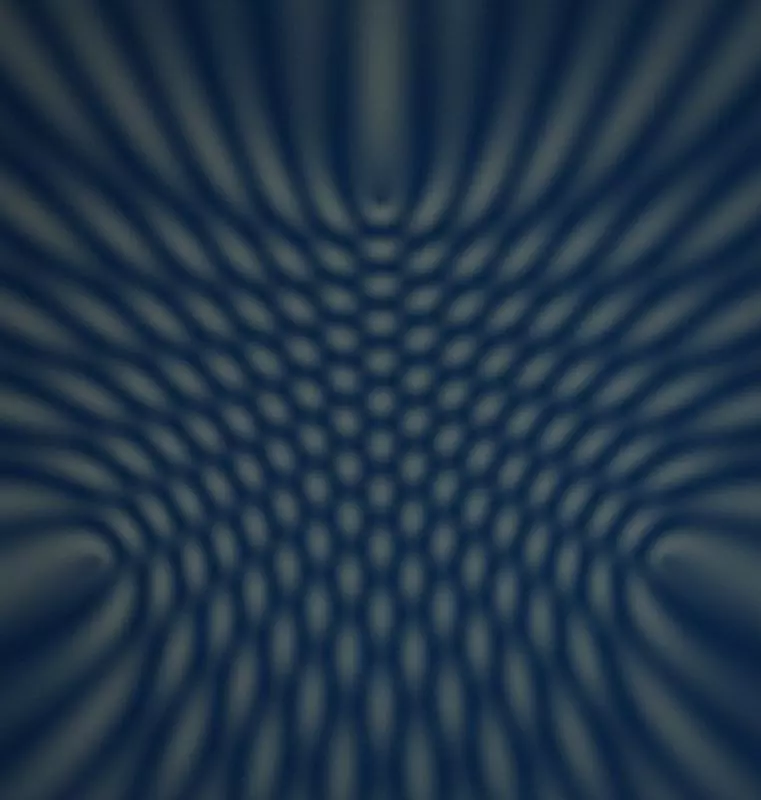 Abstract interference pattern from three wave sources in gold and blue